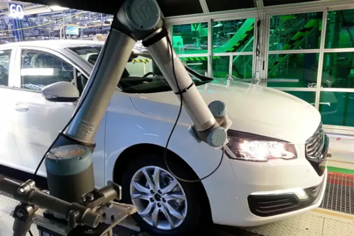 A car being inspected with the GapFlex robotic system integrated in the production line